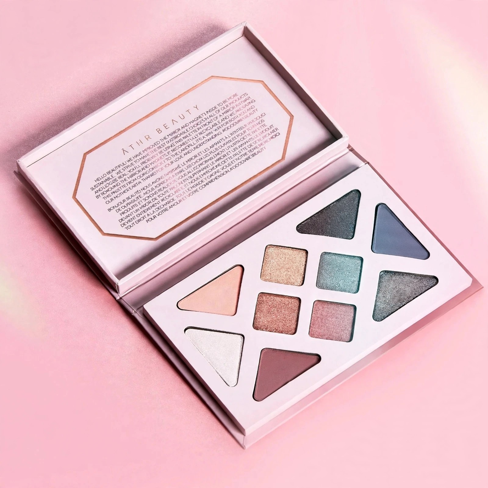 Open Rose Quartz eyeshadow palette on pink background.