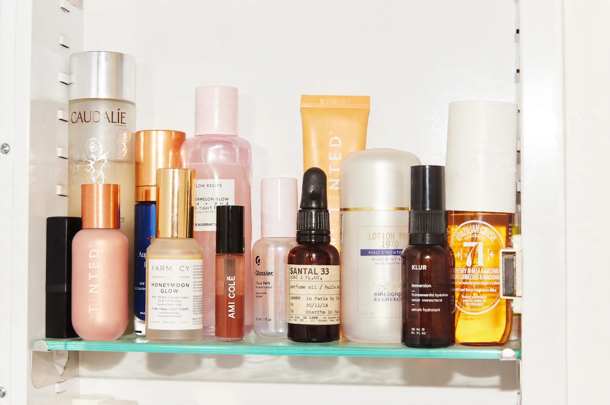 Ami Colé products arranged among skincare on a shelf.