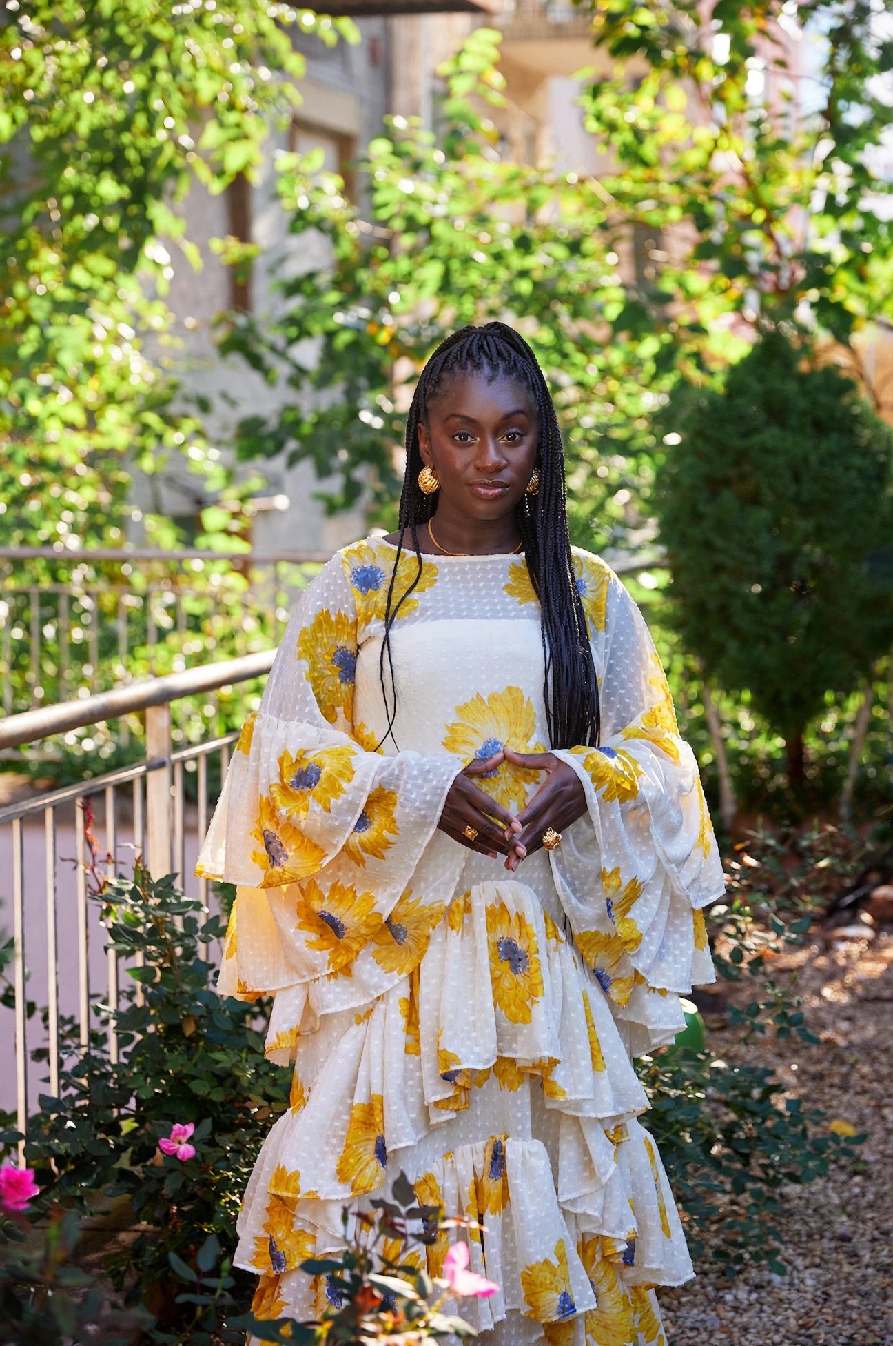 Founder Diarrha NDiaye-Mbaye standing outdoors in floral dress.