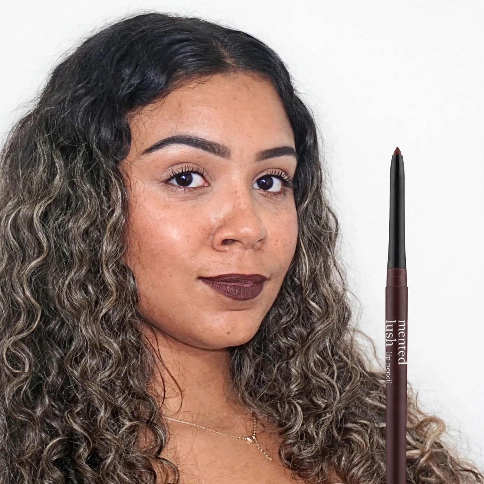 Woman with curly hair wearing dark Mented lip color.