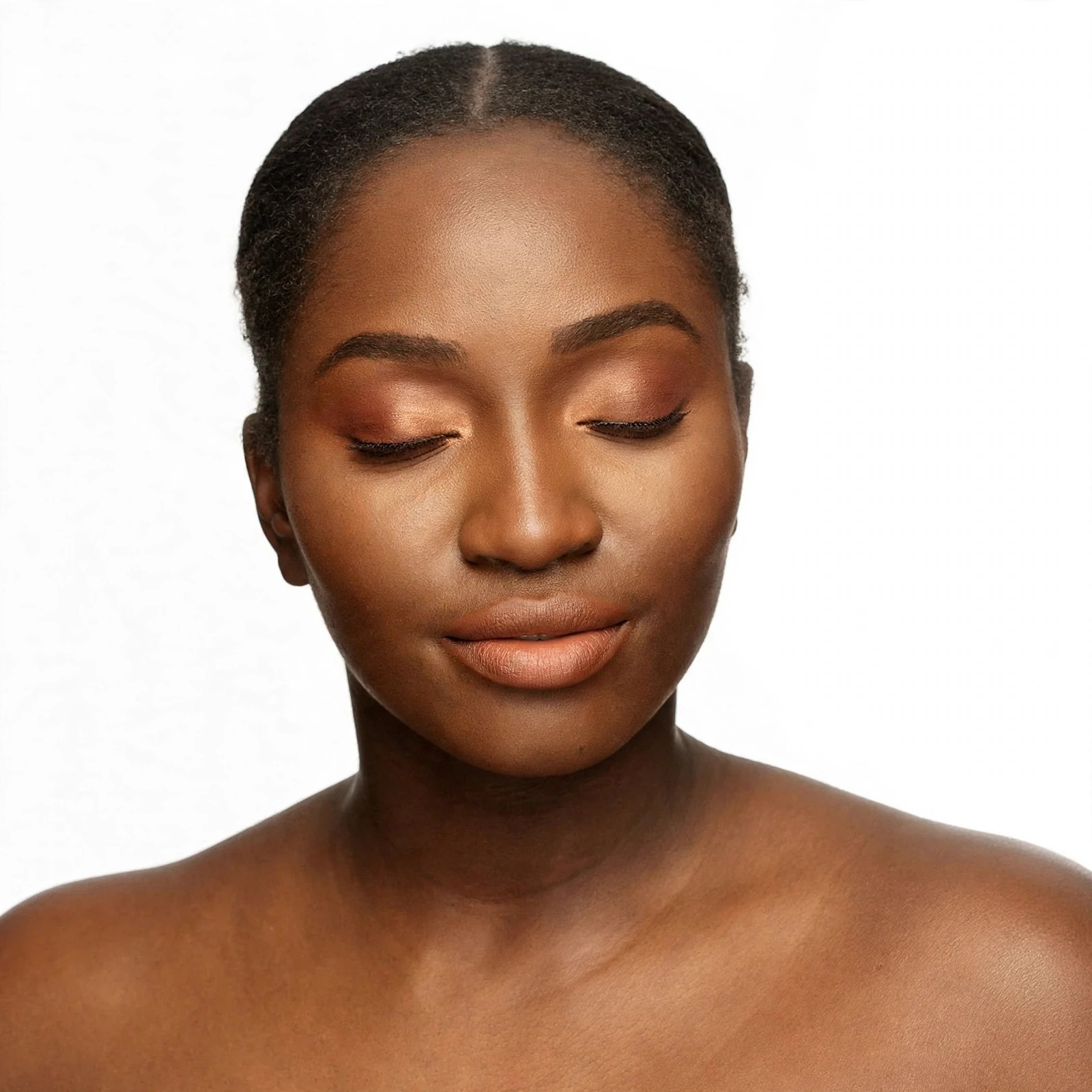 Woman with eyes closed wearing Mented eye and lip makeup.